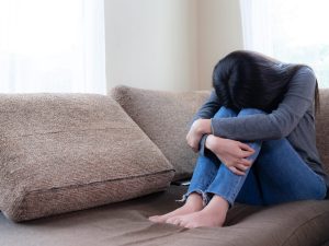 Emotional young woman was depressed on sofa